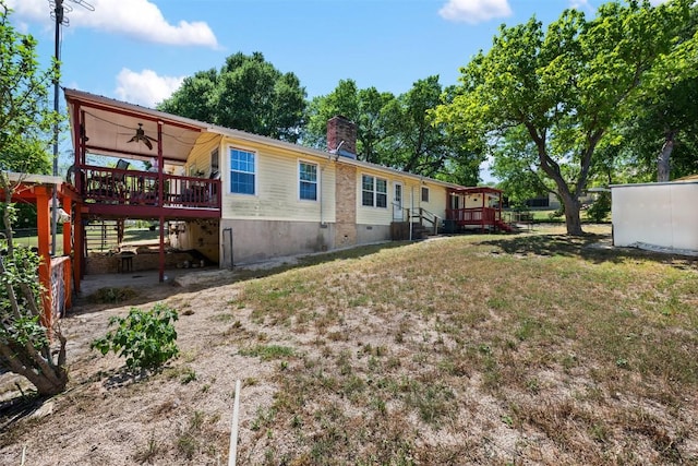 back of house with a wooden deck, a chimney, ceiling fan, crawl space, and a yard