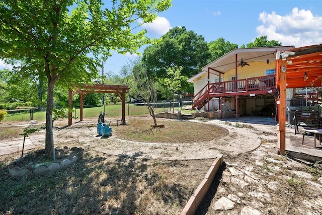 exterior space featuring stairs, a patio, a deck, a pergola, and fence