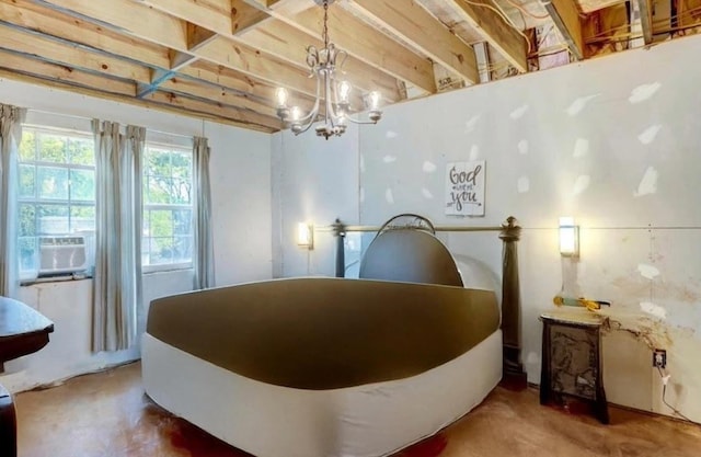 bedroom featuring cooling unit, concrete floors, and a chandelier