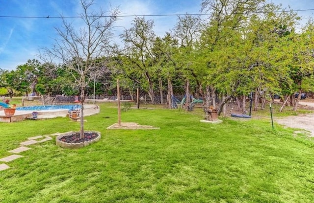 view of yard with an outdoor pool