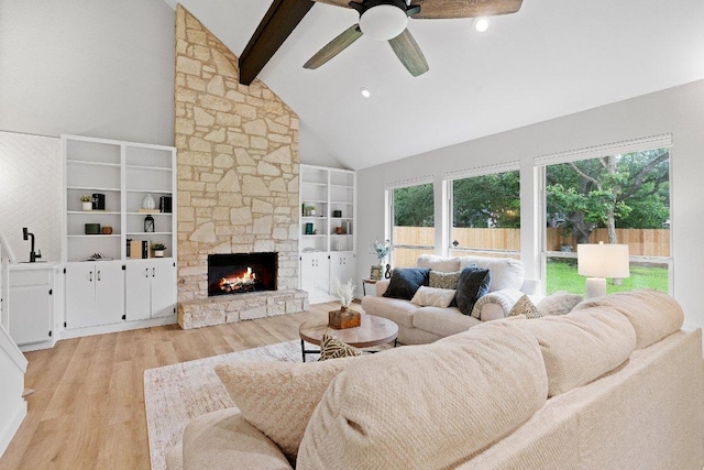 10416 Doering Ln, Austin, TX 78750 - living room featuring beamed ceiling, high vaulted ceiling, light wood-type flooring, a ceiling fan, and a fireplace