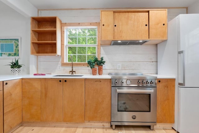 1405 Cometa St, Austin, TX 78721 - kitchen featuring stainless steel range, freestanding refrigerator, extractor fan, and light countertops