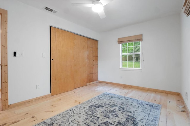 1405 Cometa St, Austin, TX 78721 - unfurnished bedroom featuring hardwood / wood-style flooring, a closet, and a ceiling fan