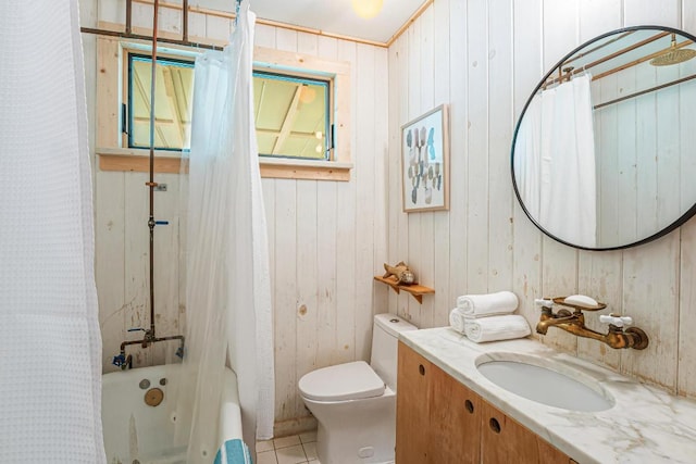 1405 Cometa St, Austin, TX 78721 - bathroom with vanity, shower / bathtub combination with curtain, wood walls, and tile patterned floors