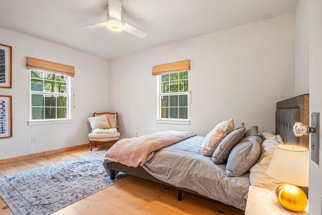 1405 Cometa St, Austin, TX 78721 - bedroom with wood finished floors, multiple windows, and a ceiling fan