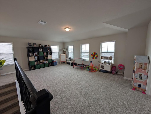 rec room with visible vents, carpet, and baseboards