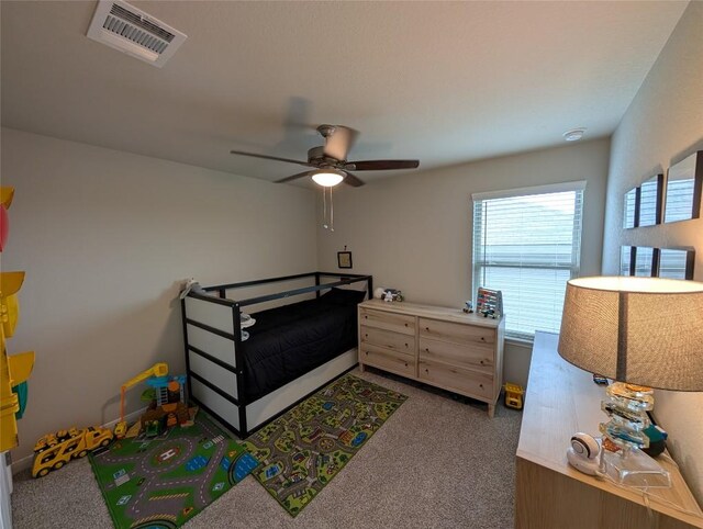 carpeted bedroom featuring visible vents, a ceiling fan, and multiple windows