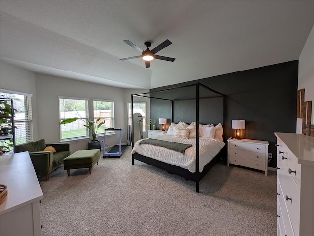 bedroom with lofted ceiling, a ceiling fan, and carpet flooring