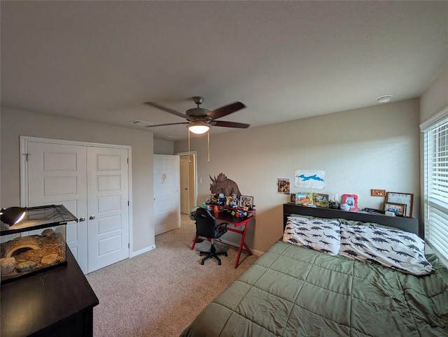 carpeted bedroom featuring baseboards, visible vents, ceiling fan, and a closet