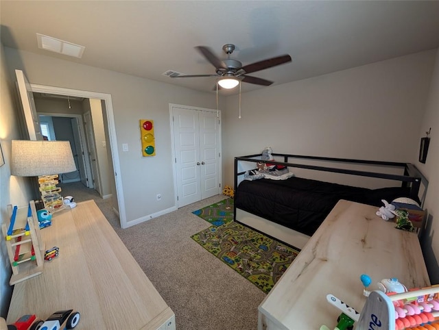 bedroom featuring carpet flooring, a closet, ceiling fan, visible vents, and baseboards
