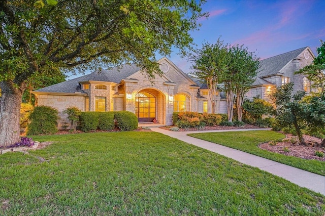 505 Newhall Cv, Austin, TX 78746 - french country style house with stone siding and a yard