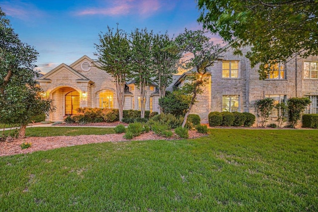 505 Newhall Cv, Austin, TX 78746 - traditional-style house featuring stone siding and a lawn