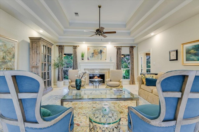 505 Newhall Cv, Austin, TX 78746 - living area featuring a raised ceiling, ceiling fan, a lit fireplace, and ornamental molding