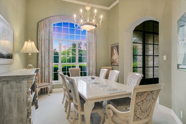 505 Newhall Cv, Austin, TX 78746 - dining room with arched walkways, healthy amount of natural light, a chandelier, carpet, and crown molding