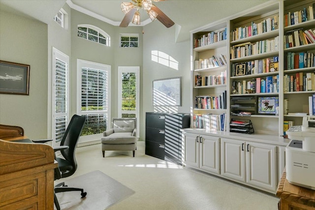 505 Newhall Cv, Austin, TX 78746 - home office featuring plenty of natural light, ceiling fan, a high ceiling, light colored carpet, and ornamental molding