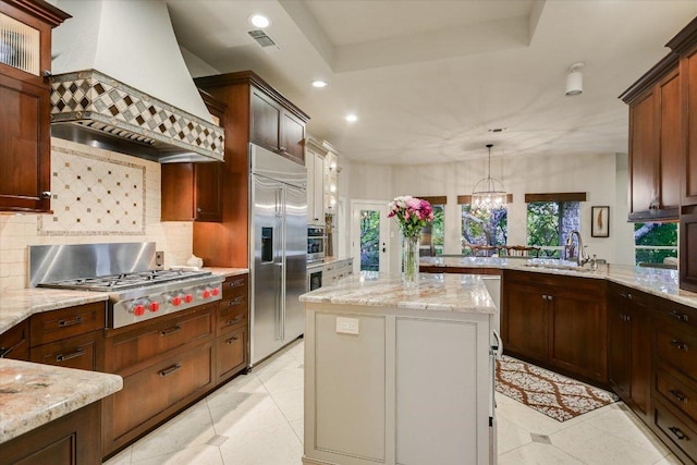 505 Newhall Cv, Austin, TX 78746 - kitchen with premium range hood, appliances with stainless steel finishes, backsplash, healthy amount of natural light, and recessed lighting
