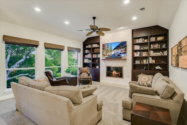 505 Newhall Cv, Austin, TX 78746 - living area with built in shelves, light colored carpet, lofted ceiling, ceiling fan, and recessed lighting