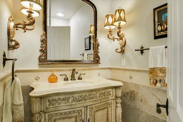 505 Newhall Cv, Austin, TX 78746 - bathroom featuring tile walls, vanity, and wainscoting