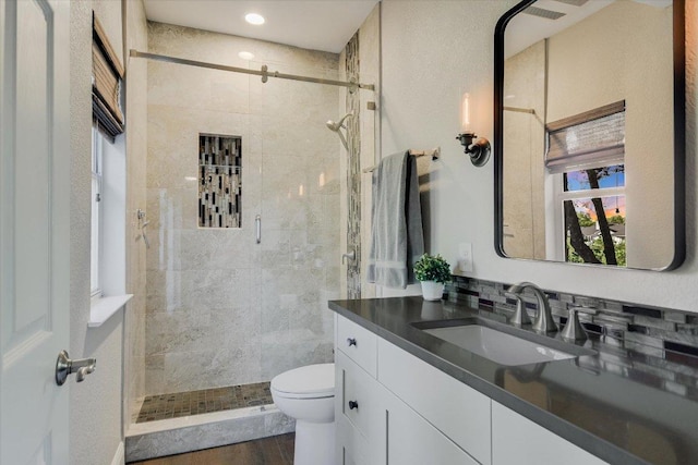 505 Newhall Cv, Austin, TX 78746 - bathroom featuring a shower stall, toilet, vanity, and wood finished floors