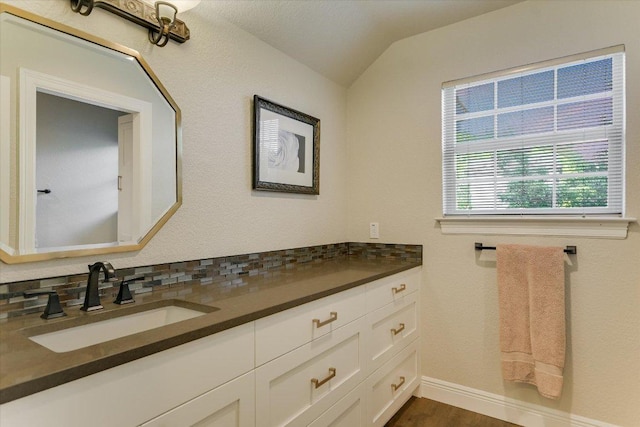 505 Newhall Cv, Austin, TX 78746 - bathroom featuring lofted ceiling, vanity, baseboards, and wood finished floors