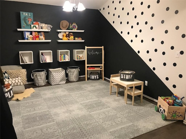 playroom with baseboards and lofted ceiling