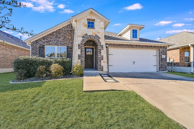 view of front of home with a garage, a front yard, stone siding, brick siding, and concrete driveway