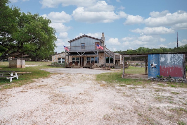 3487 Rust, Spring Branch, TX 78070 - view of front of home featuring stairs, a chimney, a deck, an outdoor structure, and a carport