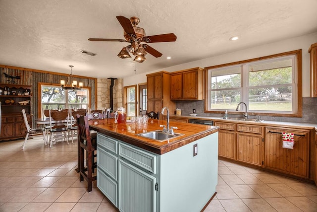 kitchen featuring light tile patterned floors, a sink, and visible vents