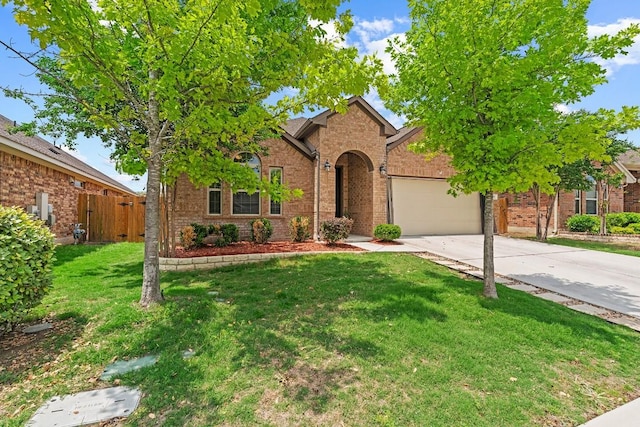 view of front of home featuring a front lawn, brick siding, concrete driveway, an attached garage, and fence