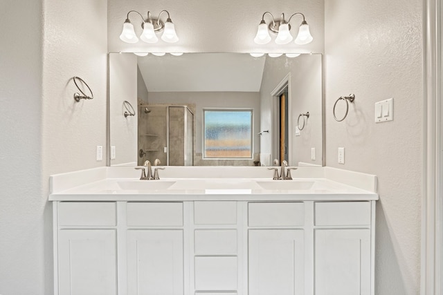 full bathroom with a shower stall, a textured wall, and a sink