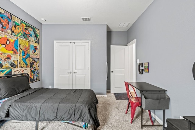 carpeted bedroom with visible vents, baseboards, and a closet