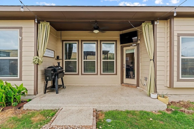 property entrance with a ceiling fan and a patio area