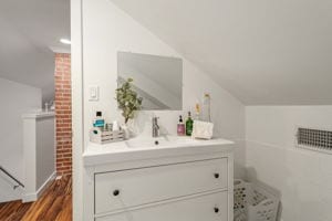 128 E Cedar St, La Grange, TX 78945 - bathroom featuring wood finished floors and vanity