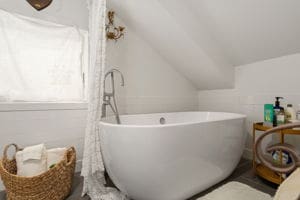 128 E Cedar St, La Grange, TX 78945 - full bath featuring a soaking tub and vaulted ceiling