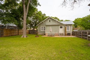 128 E Cedar St, La Grange, TX 78945 - rear view of house with a patio, a fenced backyard, and a yard