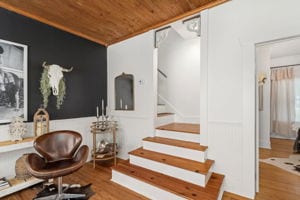 128 E Cedar St, La Grange, TX 78945 - sitting room with stairs, wooden ceiling, and wood finished floors