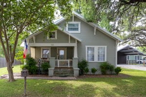 128 E Cedar St, La Grange, TX 78945 - view of front of home with a carport, a porch, and a front lawn