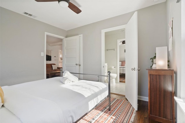 bedroom featuring wood finished floors, visible vents, and a ceiling fan