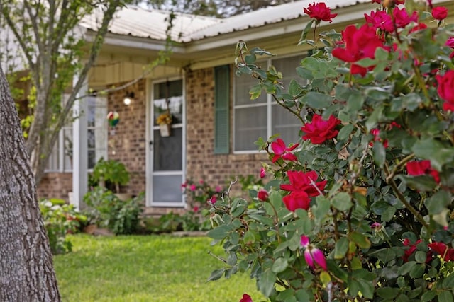 1727 Fm 2503, Fayetteville, TX 78940 - view of exterior entry featuring a yard, brick siding, and metal roof
