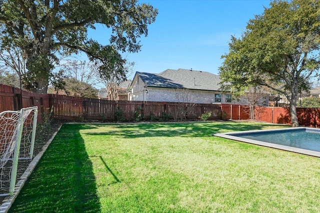view of yard featuring a fenced in pool and a fenced backyard