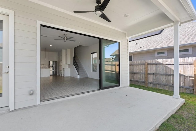 view of patio / terrace featuring fence and ceiling fan