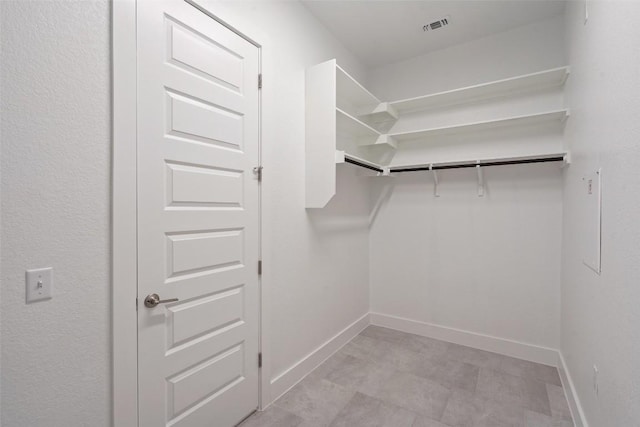 spacious closet featuring visible vents