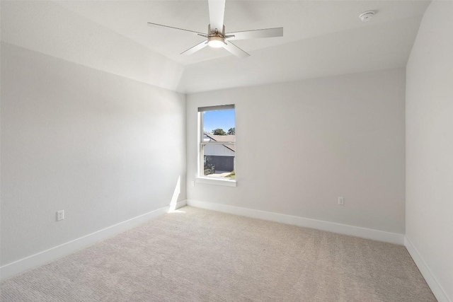 unfurnished room featuring light colored carpet, ceiling fan, and baseboards