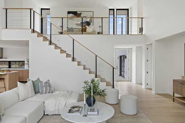 105 Scamper Cv, Lakeway, TX 78734 - living area featuring a towering ceiling, stairway, and light wood finished floors