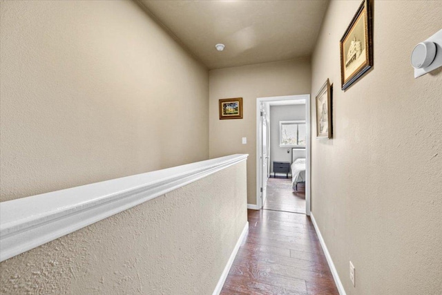 2605 Enfield Rd Unit 209, Austin, TX 78703 - hall featuring dark wood-type flooring, baseboards, and a textured wall