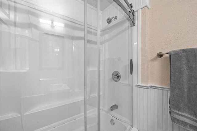 2605 Enfield Rd Unit 209, Austin, TX 78703 - bathroom featuring a textured wall and combined bath / shower with glass door
