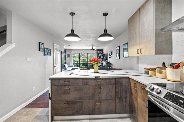 2605 Enfield Rd Unit 209, Austin, TX 78703 - kitchen with a peninsula, wall chimney exhaust hood, stainless steel electric stove, dark brown cabinetry, and pendant lighting