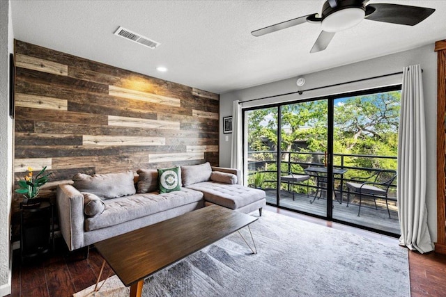 2605 Enfield Rd Unit 209, Austin, TX 78703 - living room with wood walls, ceiling fan, wood finished floors, a textured ceiling, and recessed lighting