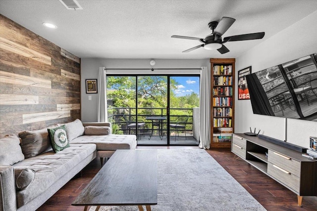 2605 Enfield Rd Unit 209, Austin, TX 78703 - living room featuring wooden walls, a ceiling fan, a textured ceiling, dark wood-style floors, and recessed lighting