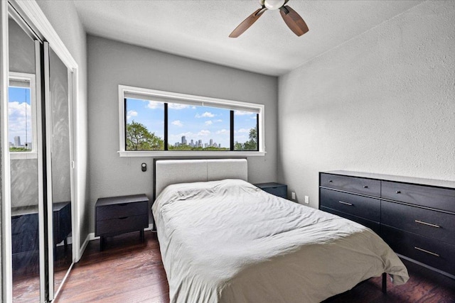 2605 Enfield Rd Unit 209, Austin, TX 78703 - bedroom with wood finished floors, a ceiling fan, and a textured wall